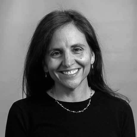 Dr Jennifer Temel smiling at the camera wearing a necklace and black shirt