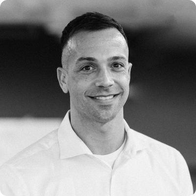 Black and white photo of Dr. Brian Dorsey smiling at the camera